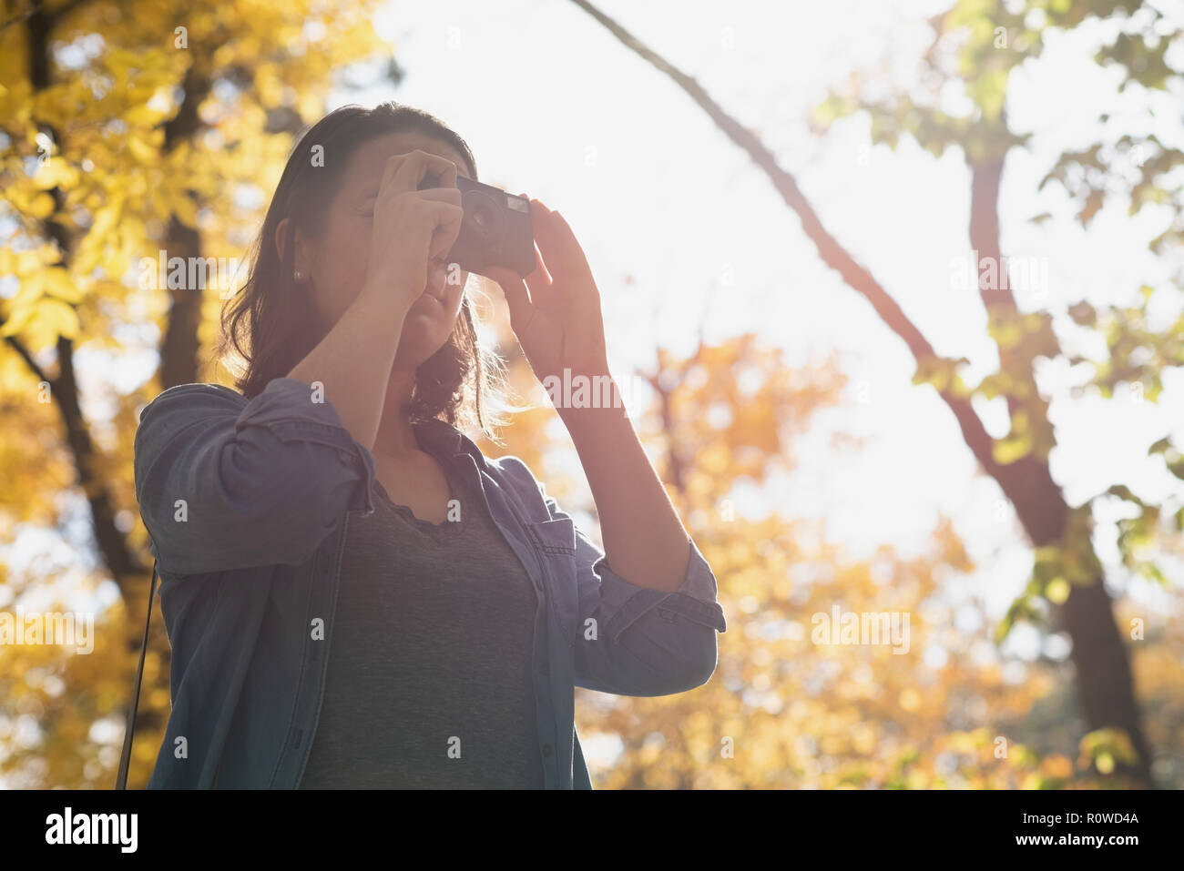 Woman clicking photos with camera Stock Photo