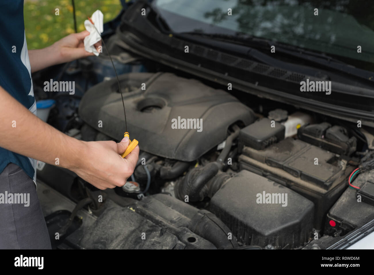 Woman checking a car during breakdown Stock Photo