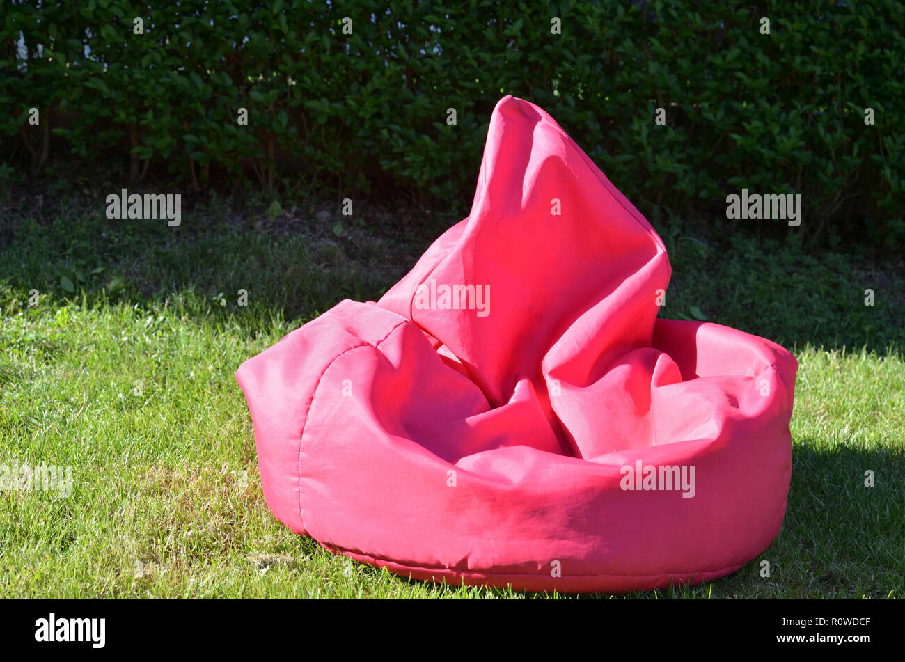 Pink bean bag on a garden lawn Stock Photo - Alamy