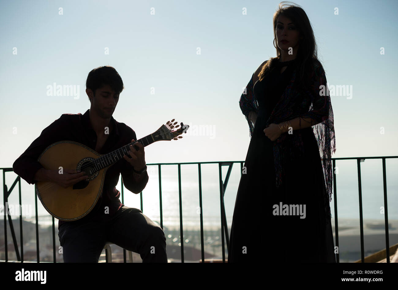Silhouette of fado band with Tagus river as background, Lisbon, Portugal Stock Photo