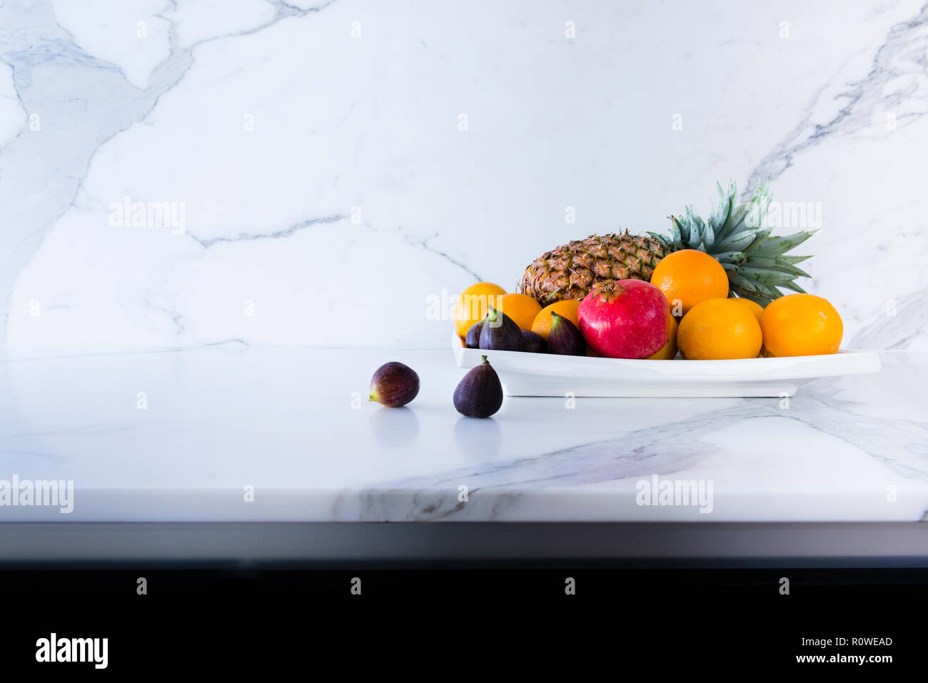 Fruit bowl on calacatta marble countertop with marble splash back in contemporary kitchen, Australia Stock Photo