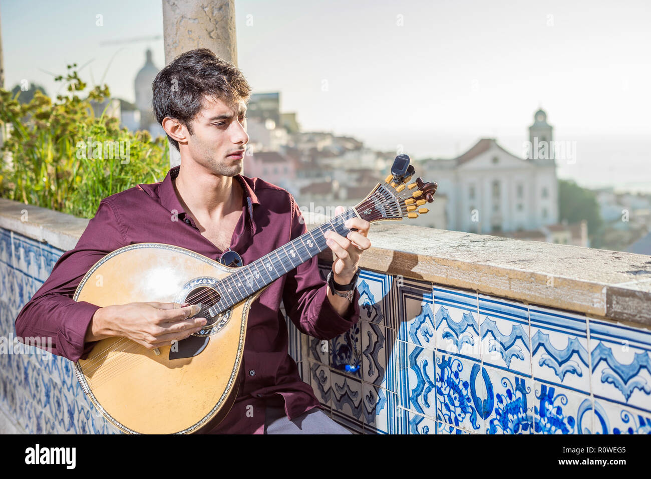 Fado musician playing on unique portuguese guitar in Alfama, Lisbon ...
