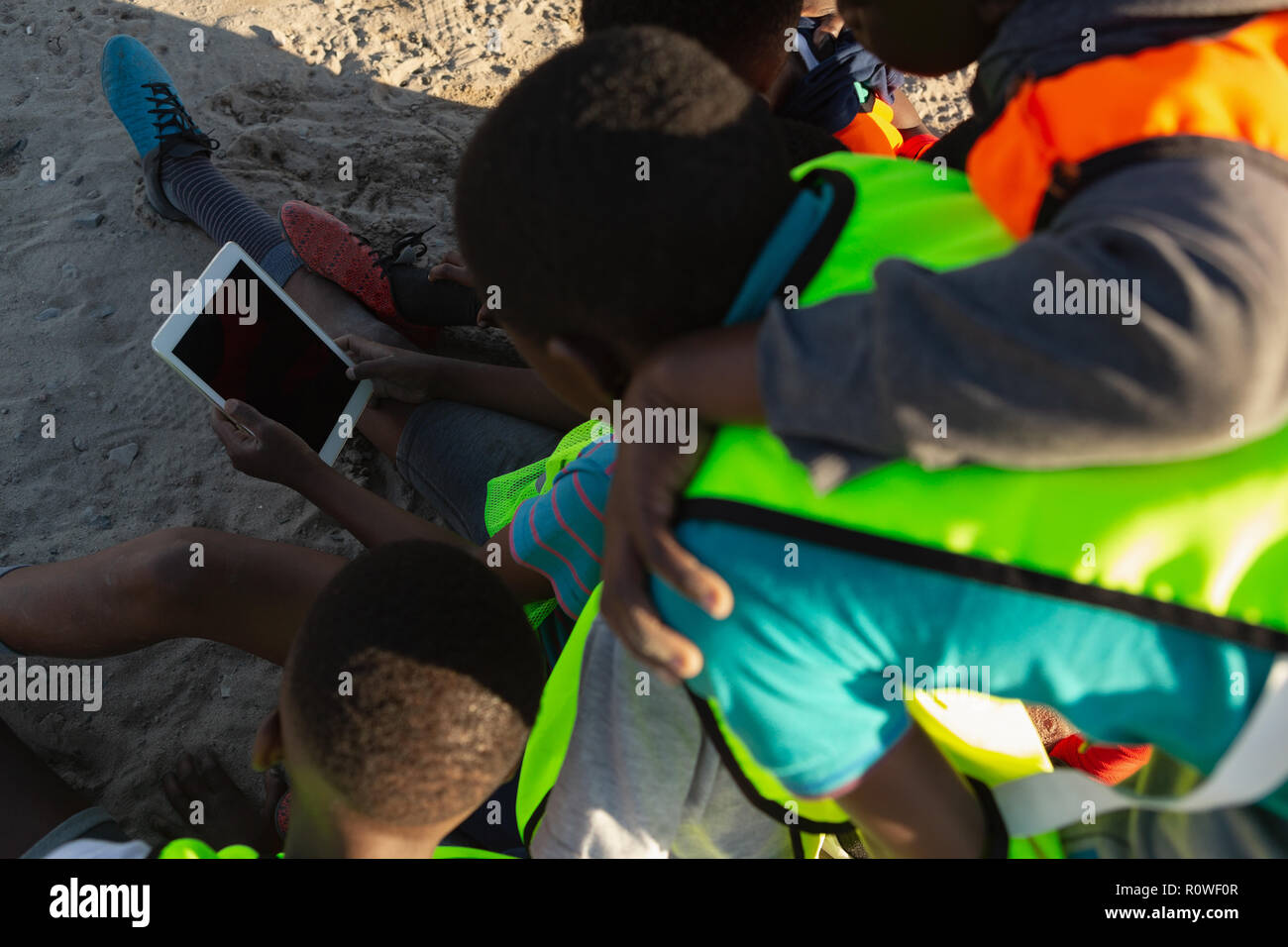 Kids using digital tablet in the ground Stock Photo