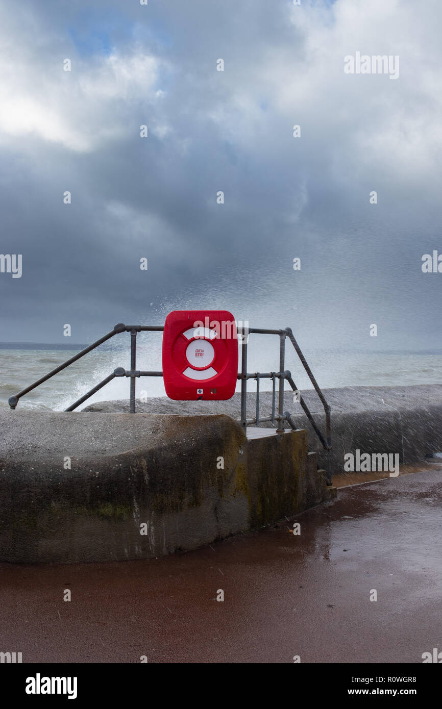 A life ring on the beach during stormy weather Stock Photo
