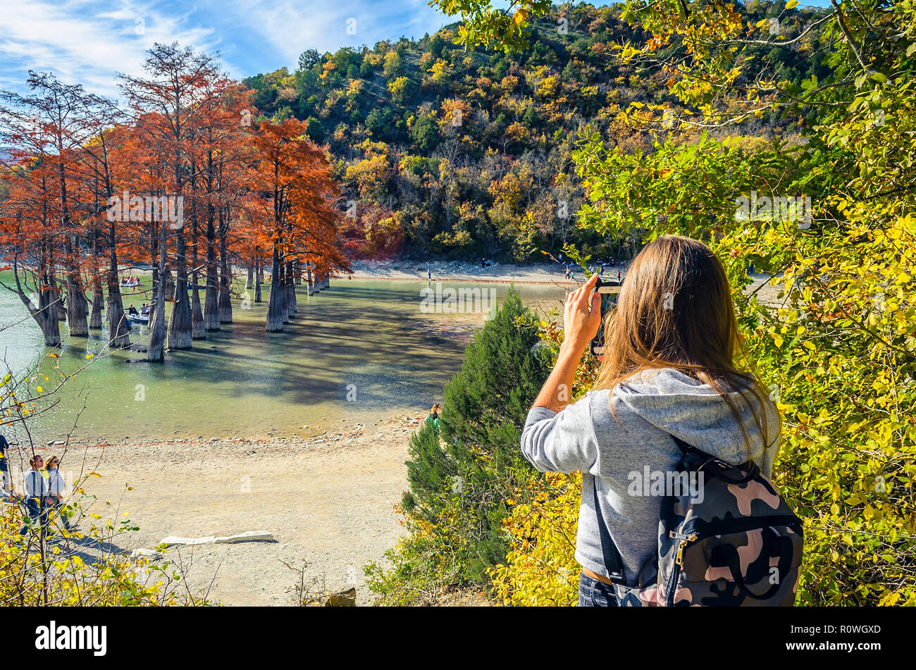 Girl taking pictures on smartphone view of cypress lake Stock Photo