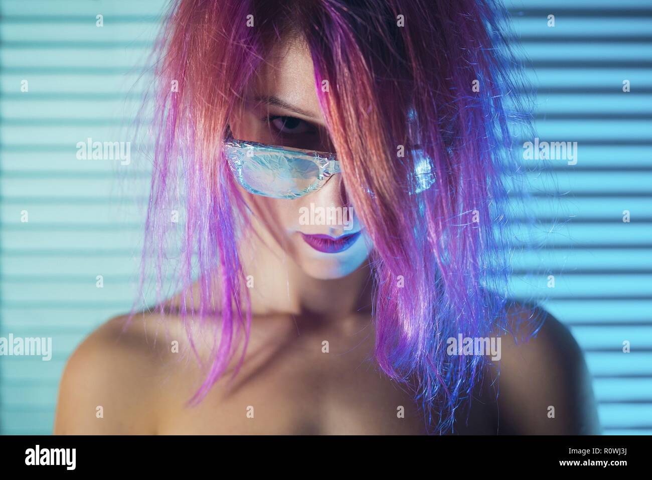 Young woman with pink hair futuristic portrait with metallic shades Stock Photo