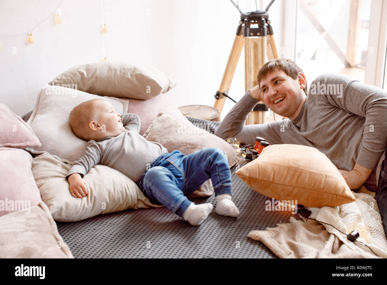 Father and baby lying on bed Stock Photo Alamy