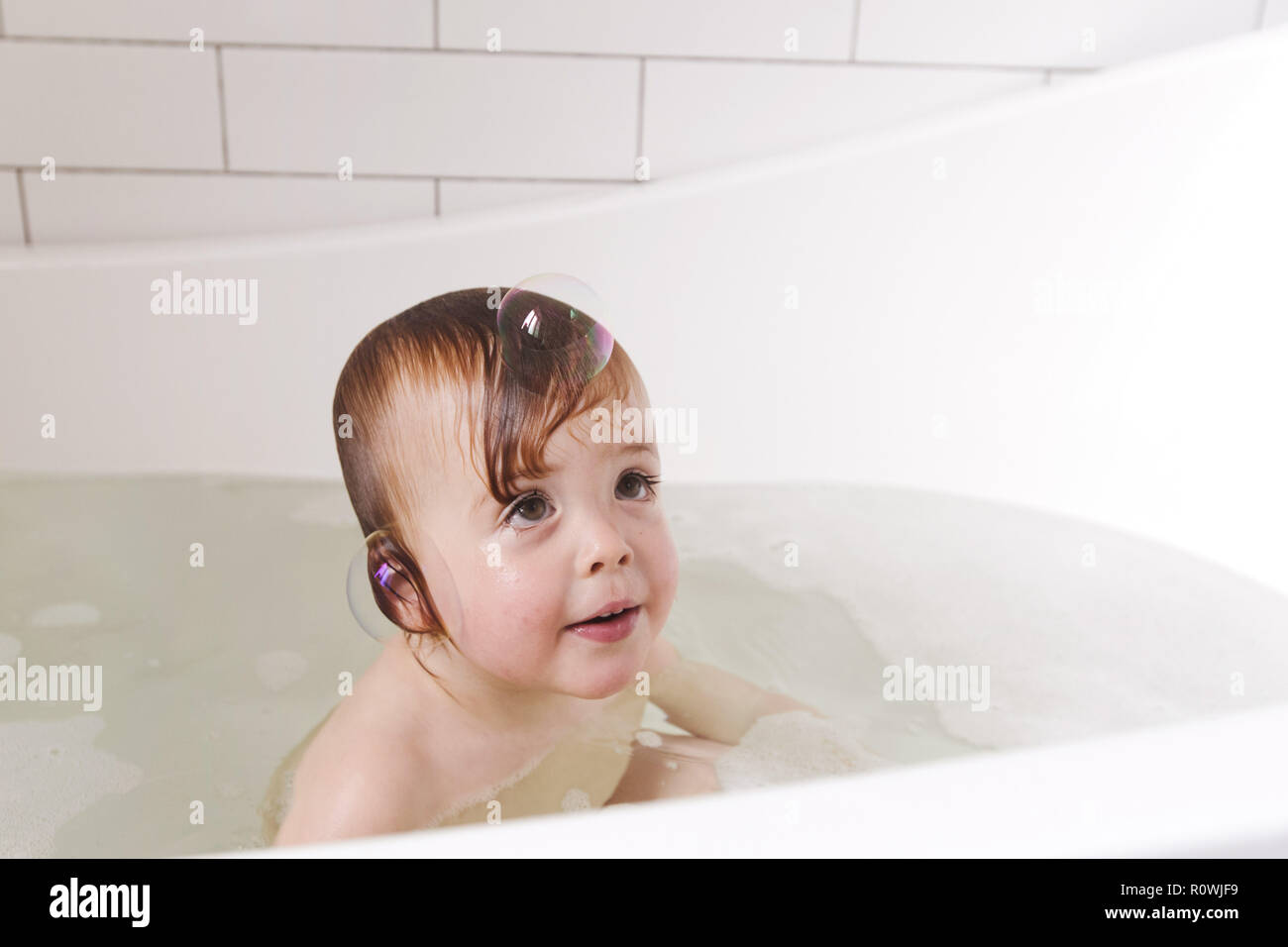 Adorable bath baby boy with soap suds on hair Stock Photo Alamy