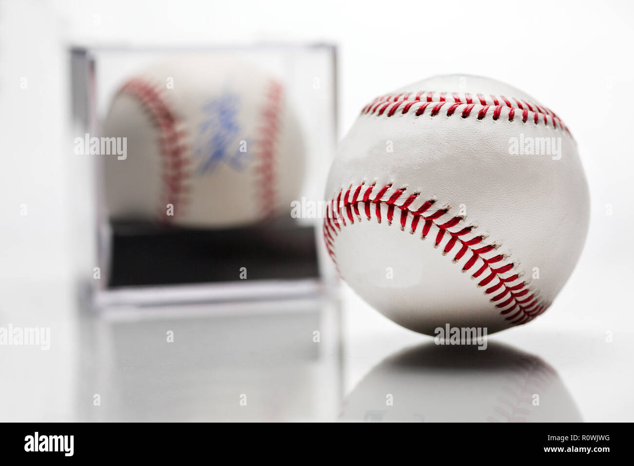 Baseball With Display Case Autographed Memorabilia Blurred In Background Isolated On White Stock Photo