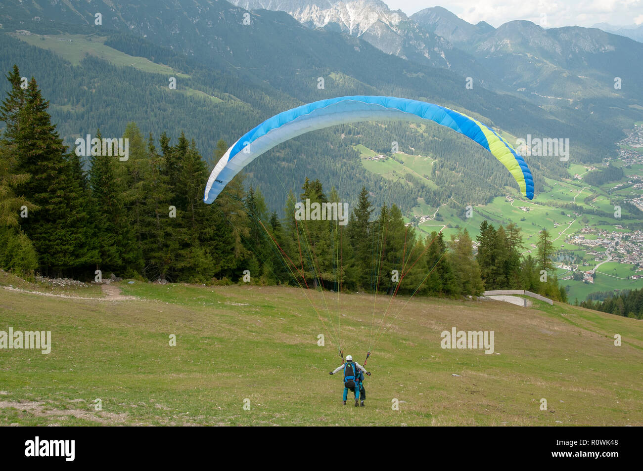 tandem Paragliding from the summit of Elfer Mountain, Neustift, Tyrol, Austria Stock Photo