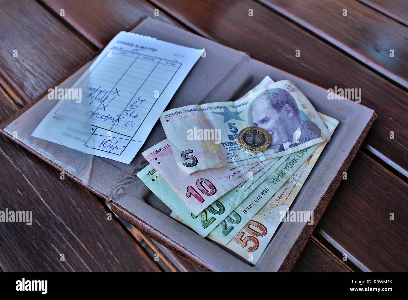 Dalyan, Turkey - July 7th 2018: Turkish Lira currency being used to pay a restaurant bill. Stock Photo