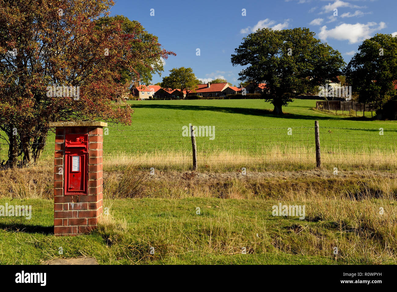 A free-standing postbox (GR) beside the village road in Goathland. Stock Photo