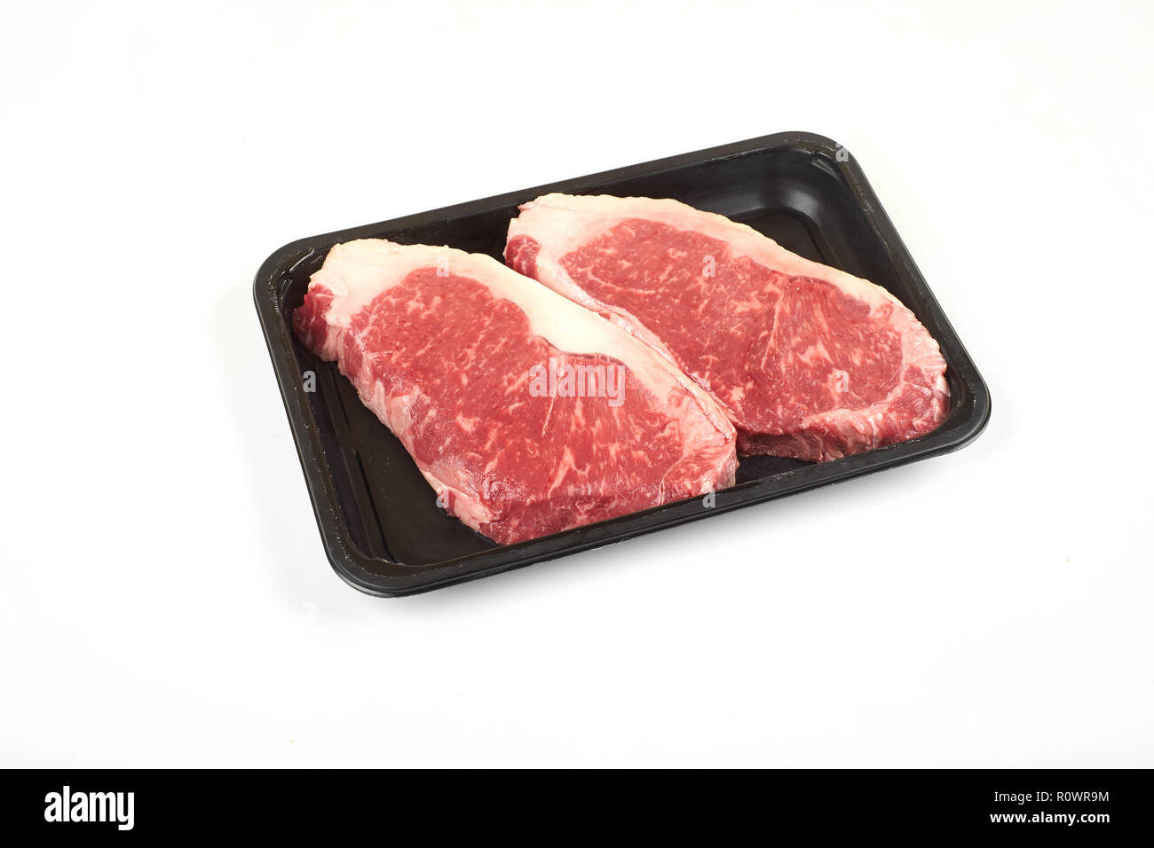 Raw sirloin beef steak in plastic packaging tray Stock Photo Alamy