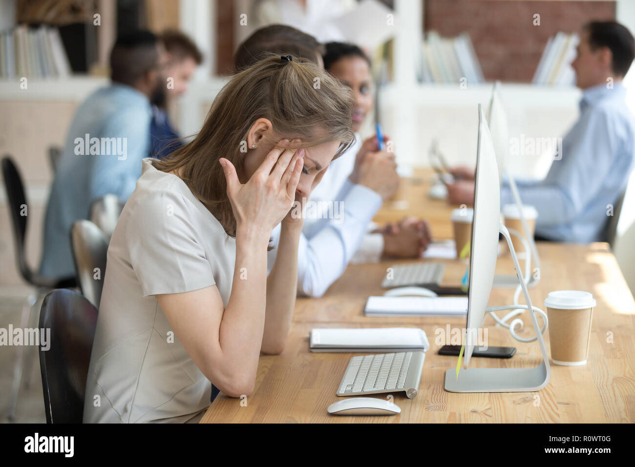 Female employee having health problems at workplace  Stock Photo
