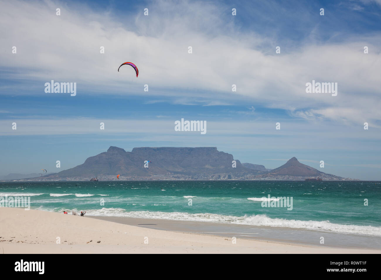 View of Table Mountain from Blouberg Beach with windsurfers Stock Photo