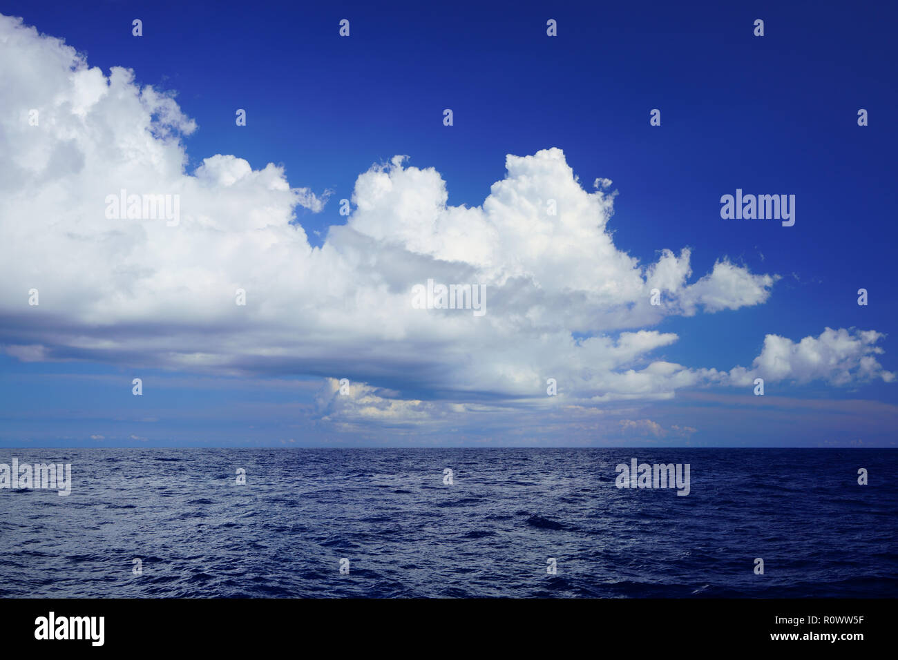 Cloudscape and deep blue waters of the Mediterranean Sea, off the coast of northern Majorca, Spain. Maritime open sea background. Stock Photo