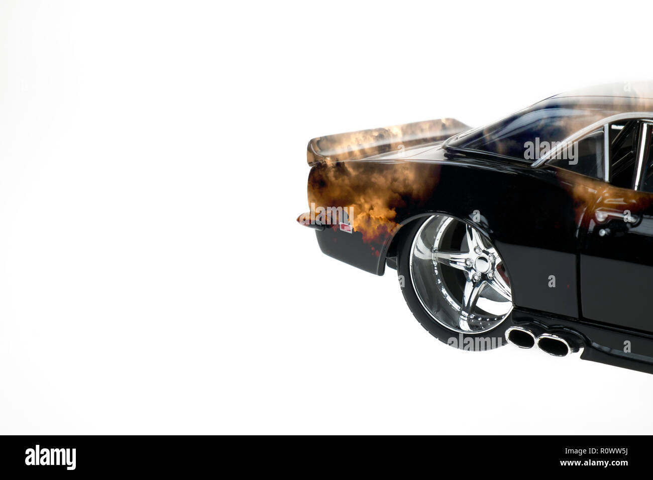 Rear view of a muscle diecast car double exposured with sunset clouds image on isolated white background Stock Photo