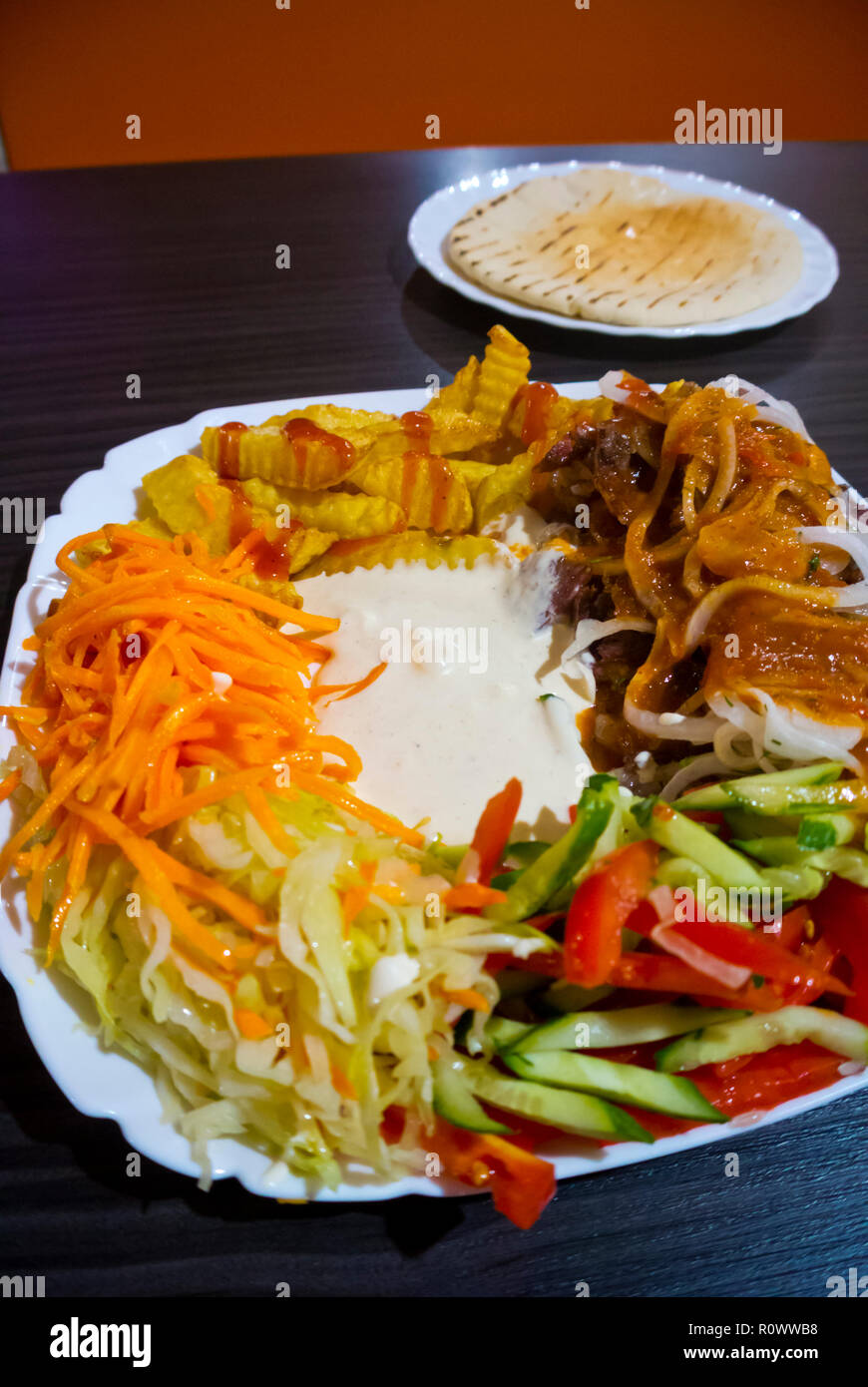Shaverma, plate of lamb kebab with fries and salad, Saint Petersburg, Russia Stock Photo