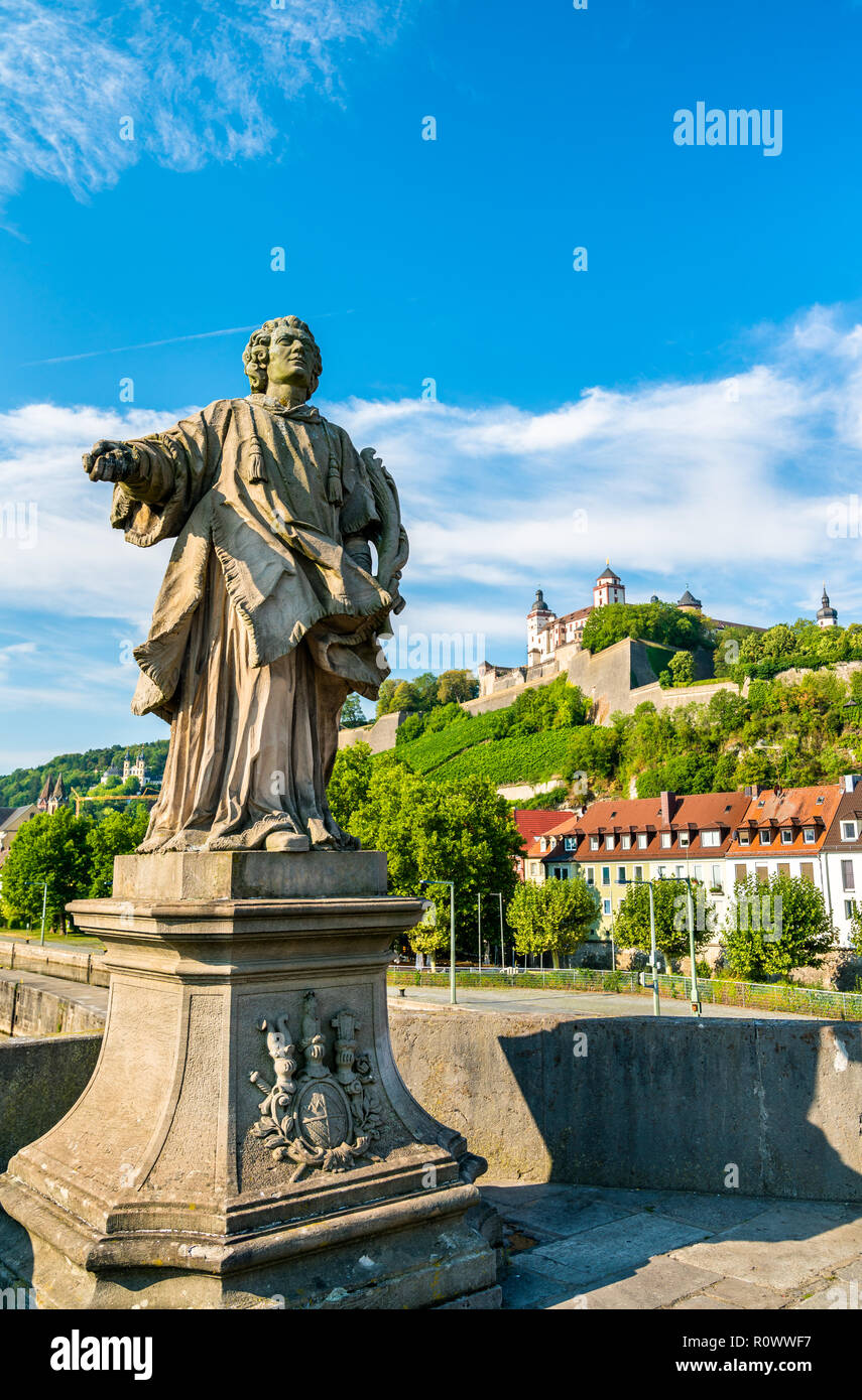 Statue on the Alte Mainbrucke and Marienberg Fortress in Wurzburg, Germany Stock Photo