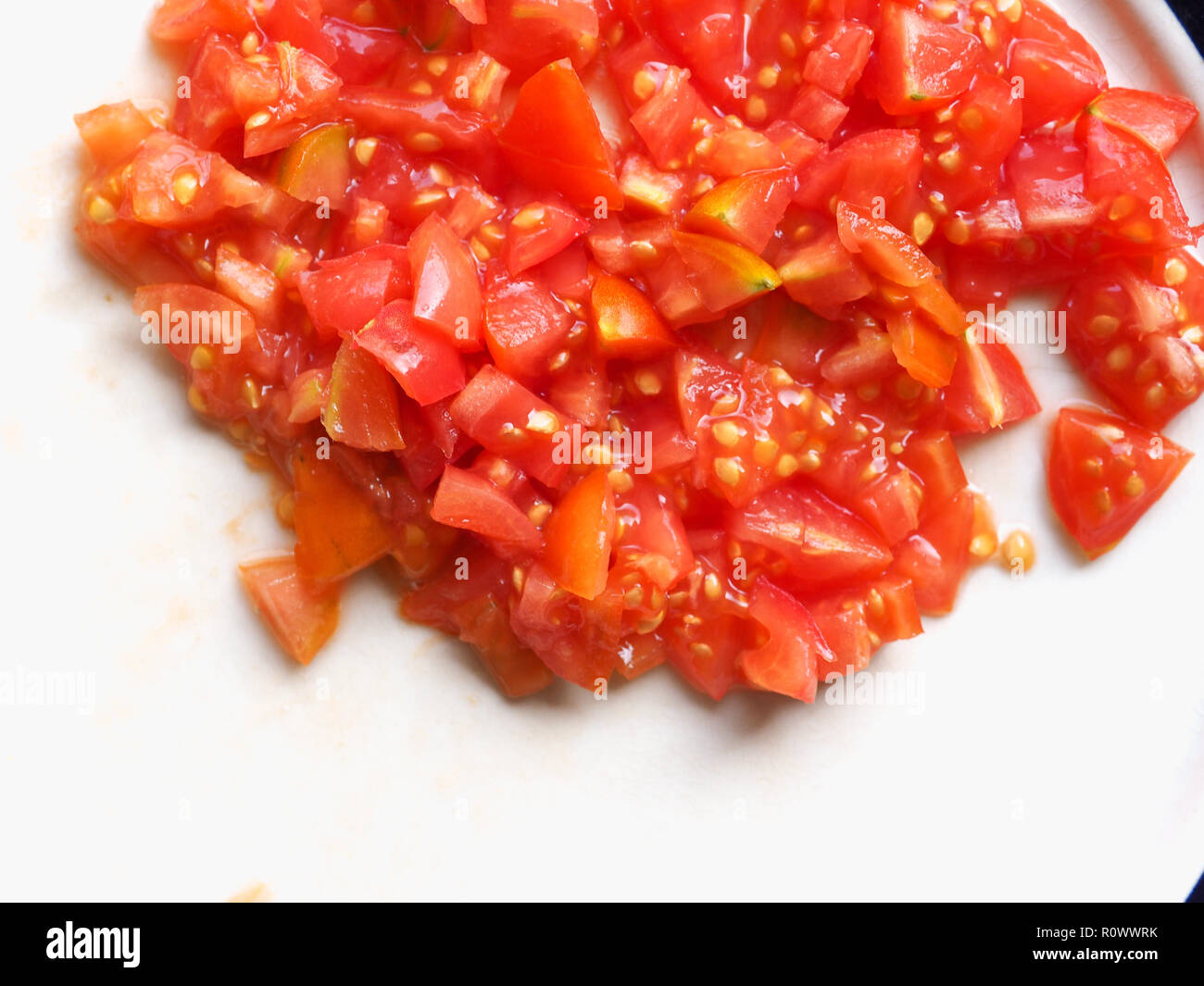 chopped tomato preparation for pizza vegetarian food Stock Photo - Alamy
