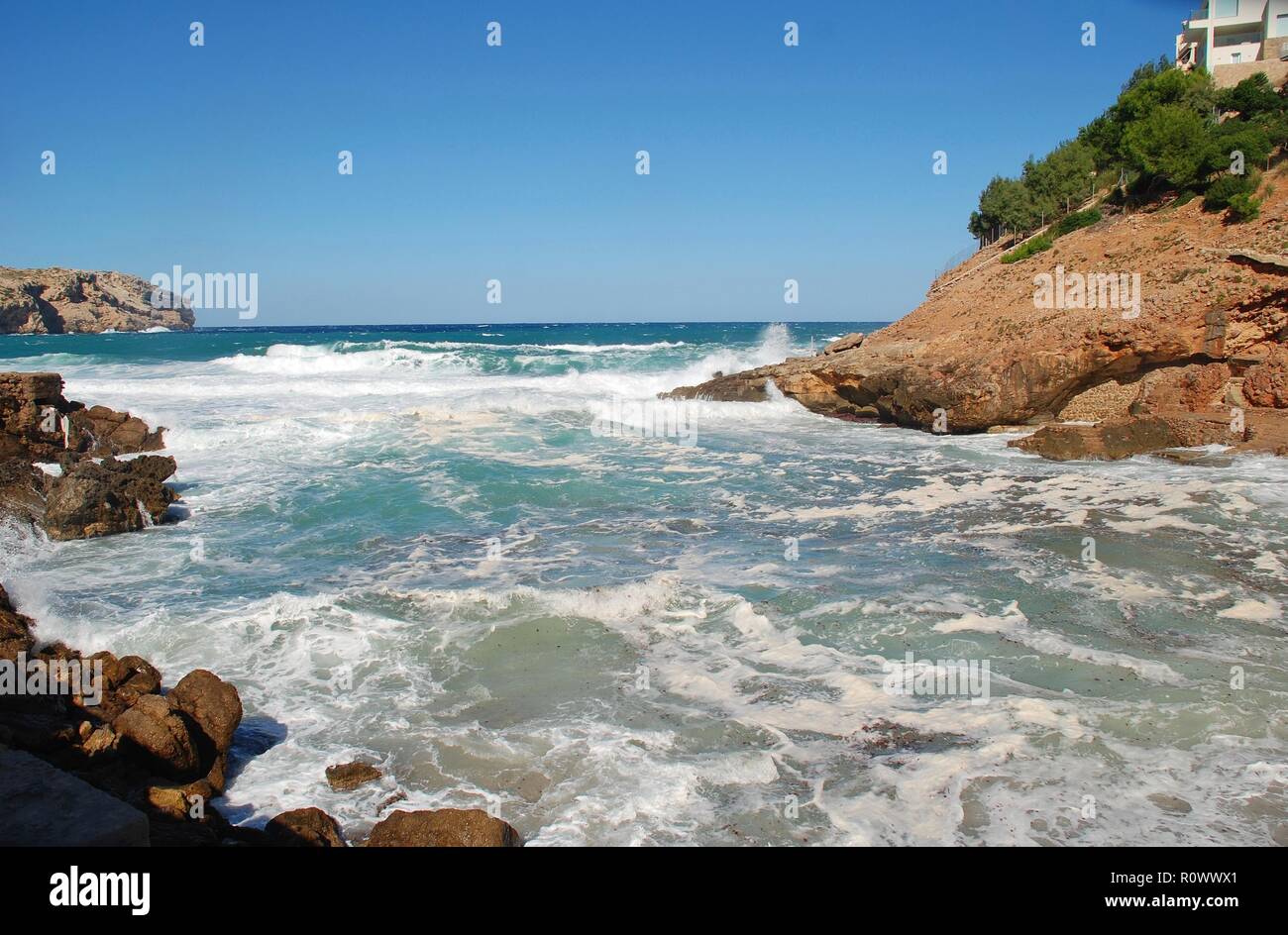 Stormy seas break on Cala Carbo beach at Cala San Vicente on the Spanish island of Majorca on October 2, 2018. Stock Photo