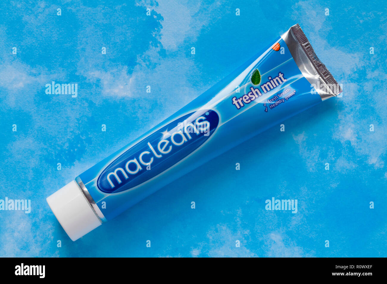 Tube of Macleans fresh mint toothpaste on blue patterned background ...