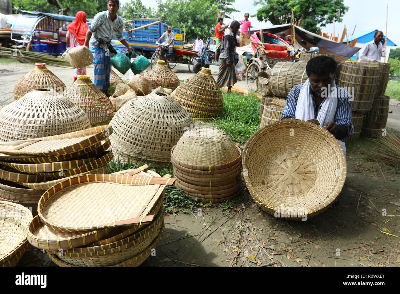 A shopkeeper display the basket made by bamboo for sale at Kaikkarateke market, Narayanganj