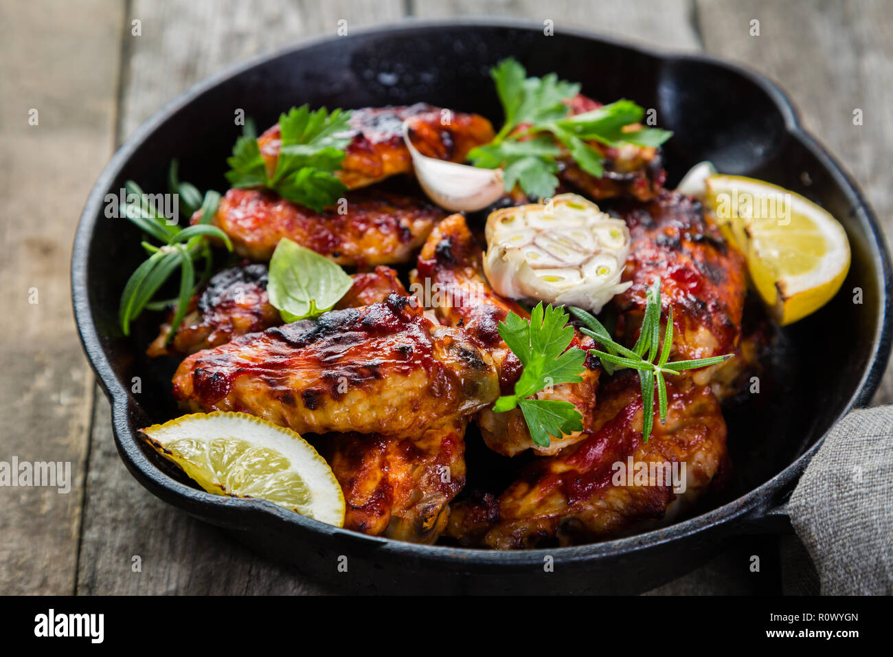 Chicken wings in cast iron skillet Stock Photo Alamy