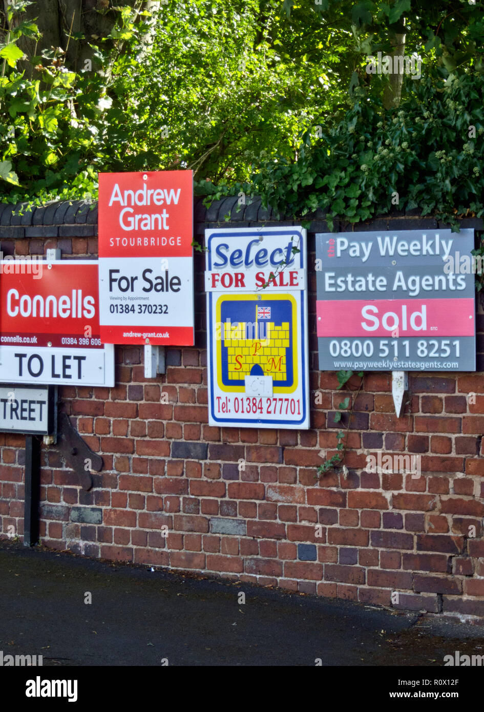 Row of To Let and For Sale Estate Agent or Real Estate Boards, UK 