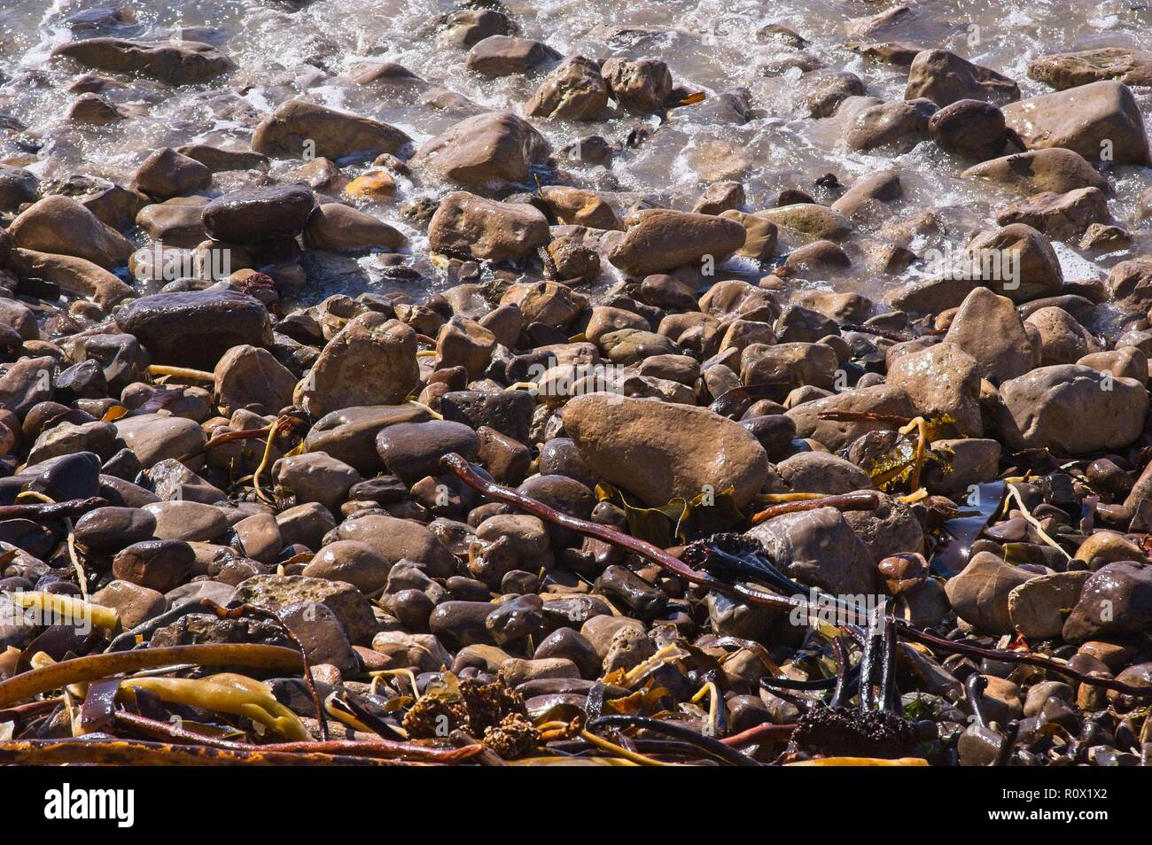 Salt Water On Rocks Rocks, stones and pebbles awash with salt water at the ocean's edge ...