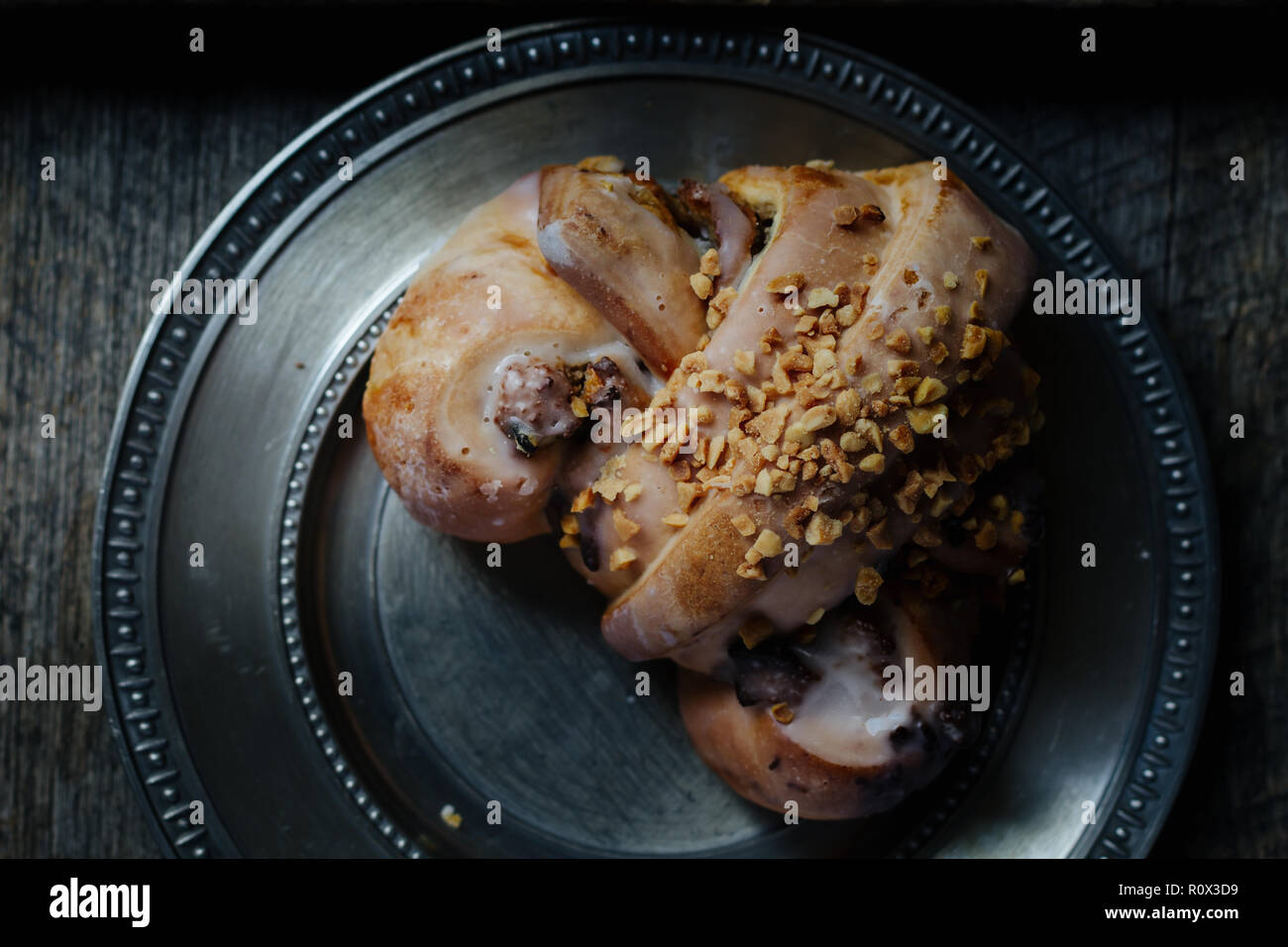 tasty polish traditional Saint Martin's croissant with white poppies, nuts and almonds called rogal swietomarcinski and wild rose fruits on wooden bac Stock Photo