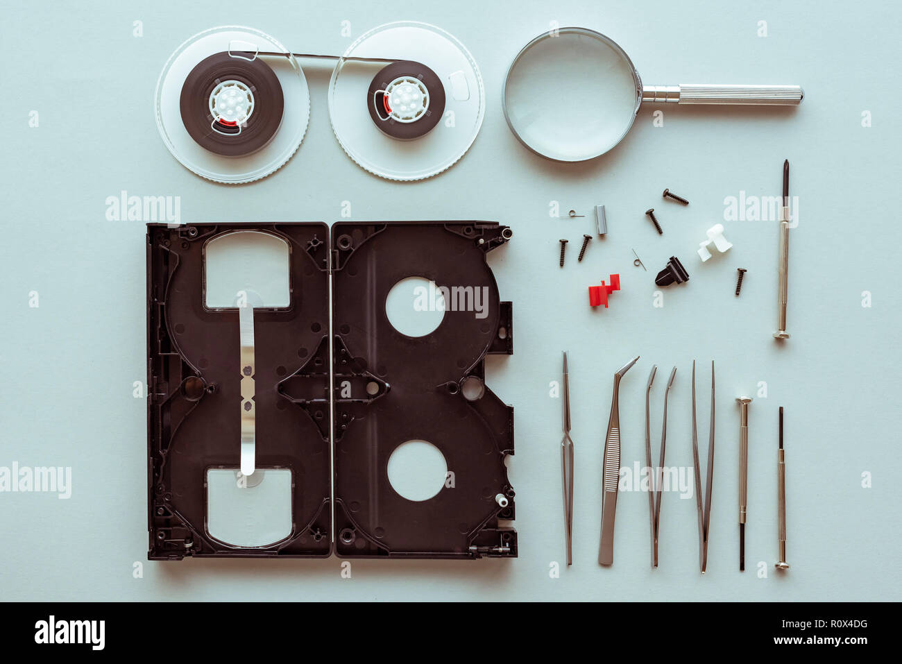 Flat lay vhs video cassette parts on pastel blue background, top view