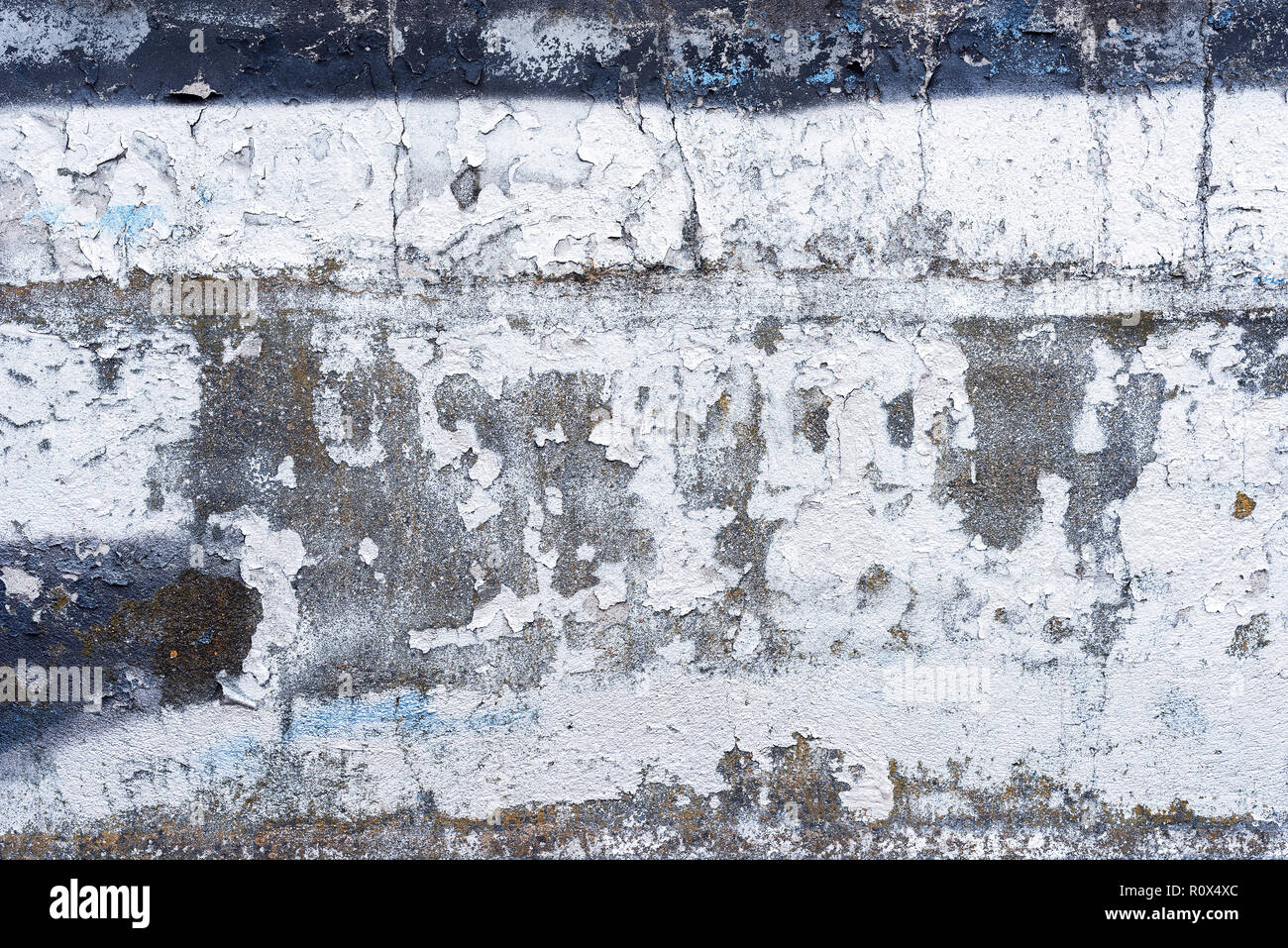 White weathered wall with paint peeling off the surface as background Stock Photo