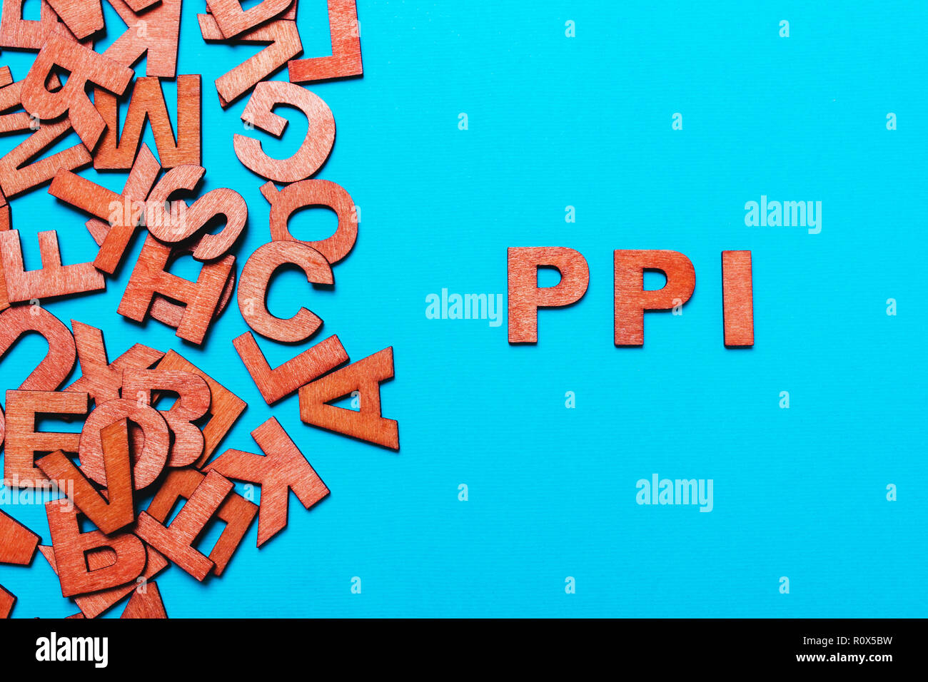 abbreviation PPI - Payment Protection Insurance.Wooden letters on blue  background Stock Photo - Alamy