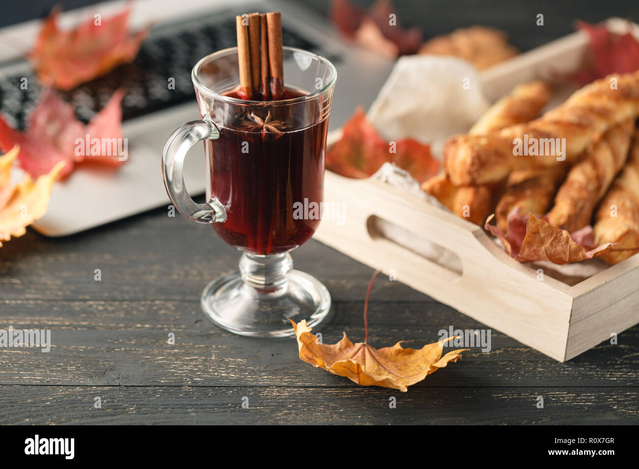 Laptop on wooden table with hot drink and cookies, working place ...
