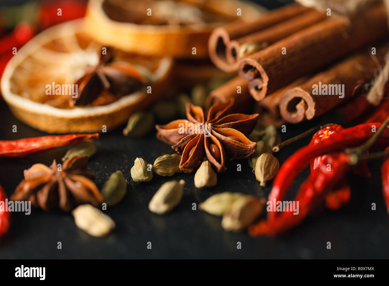 Different spices and herbs on a black slate. Stock Photo