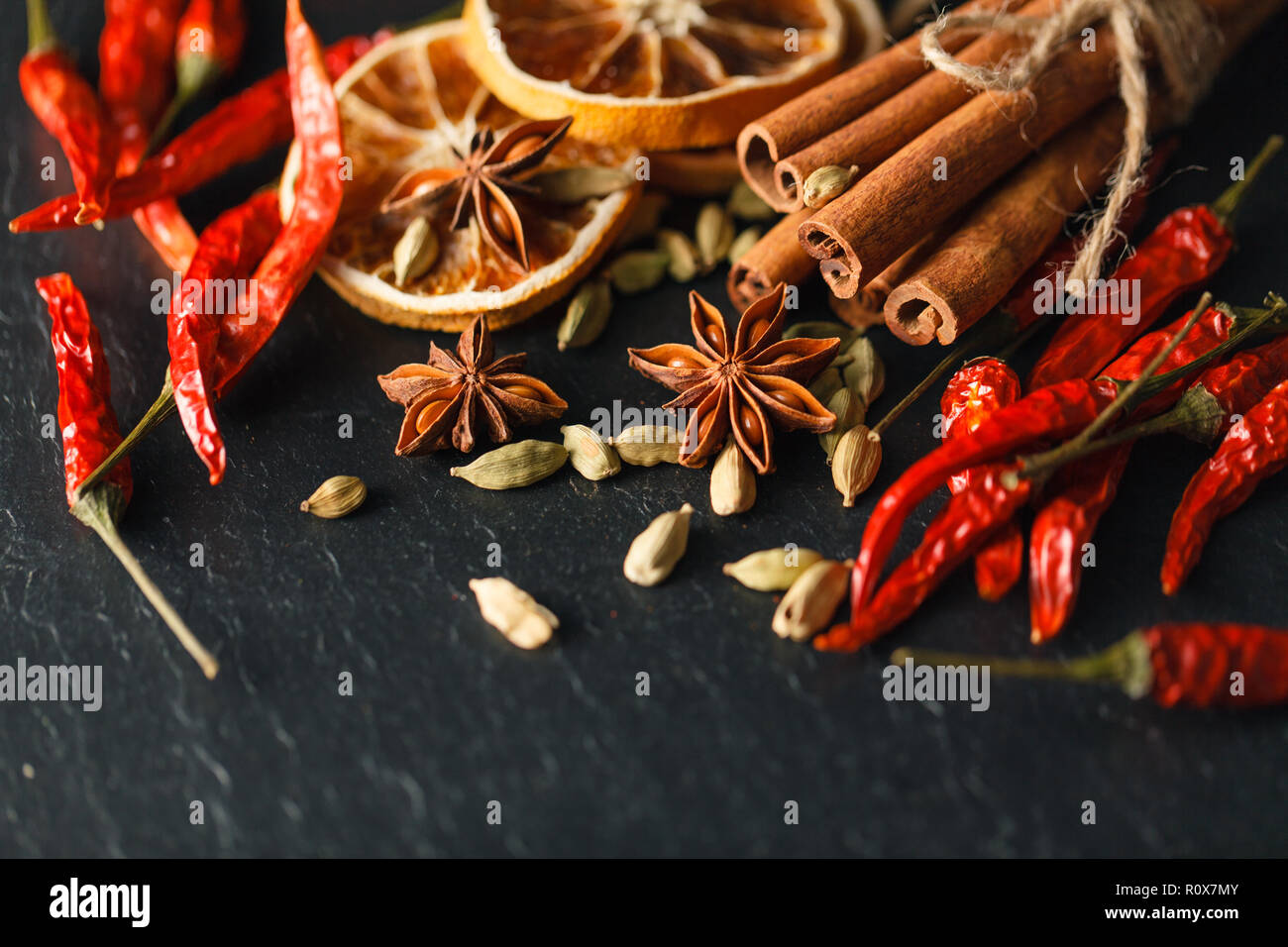 Different spices and herbs on a black slate. Stock Photo