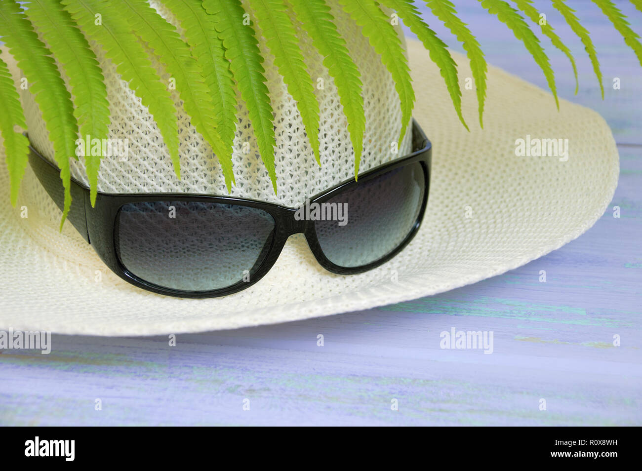 Straw hat and sunglasses. On a wooden background Stock Photo - Alamy