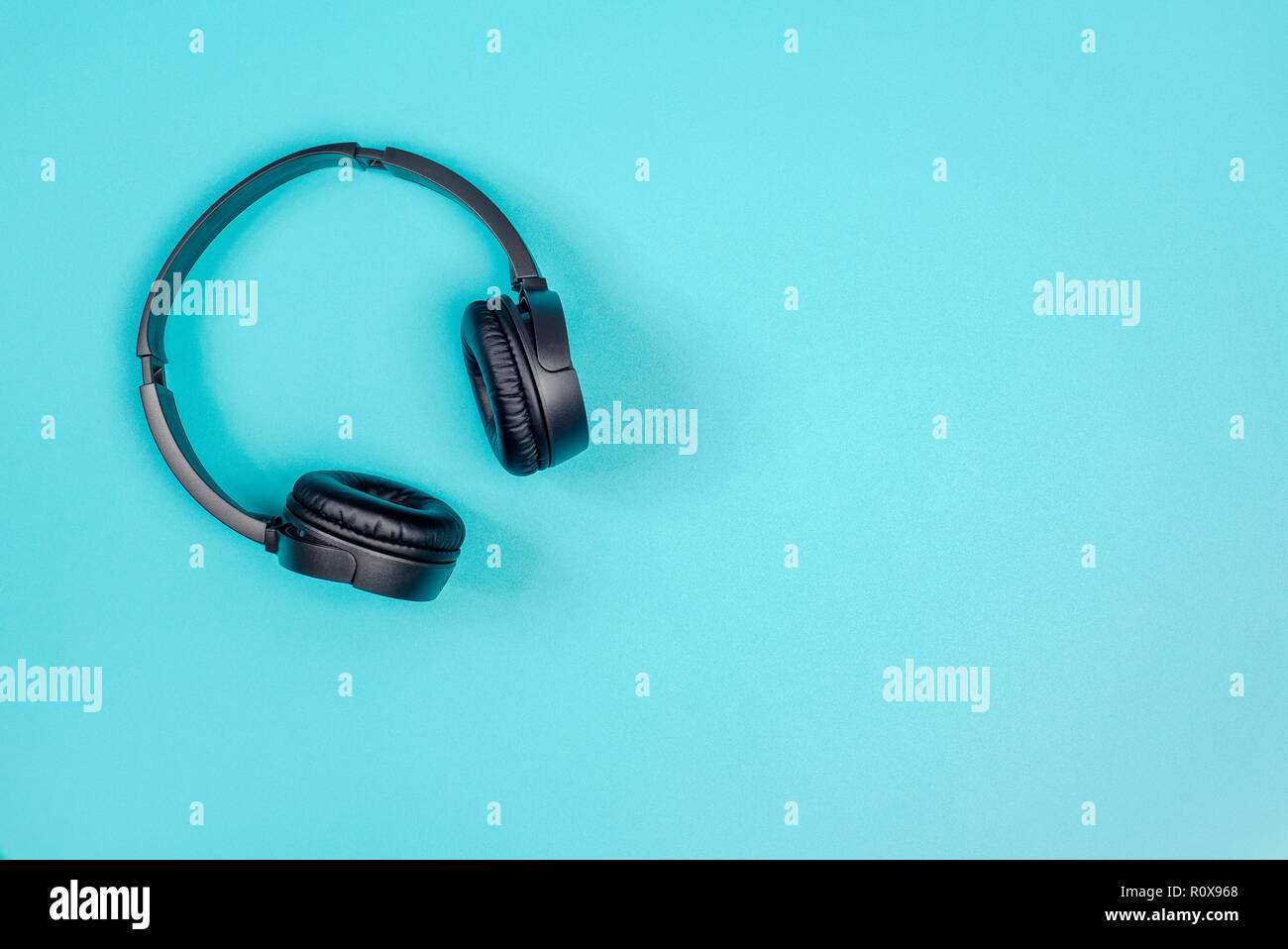 Black headphone on pastel green metal table background Stock Photo Alamy