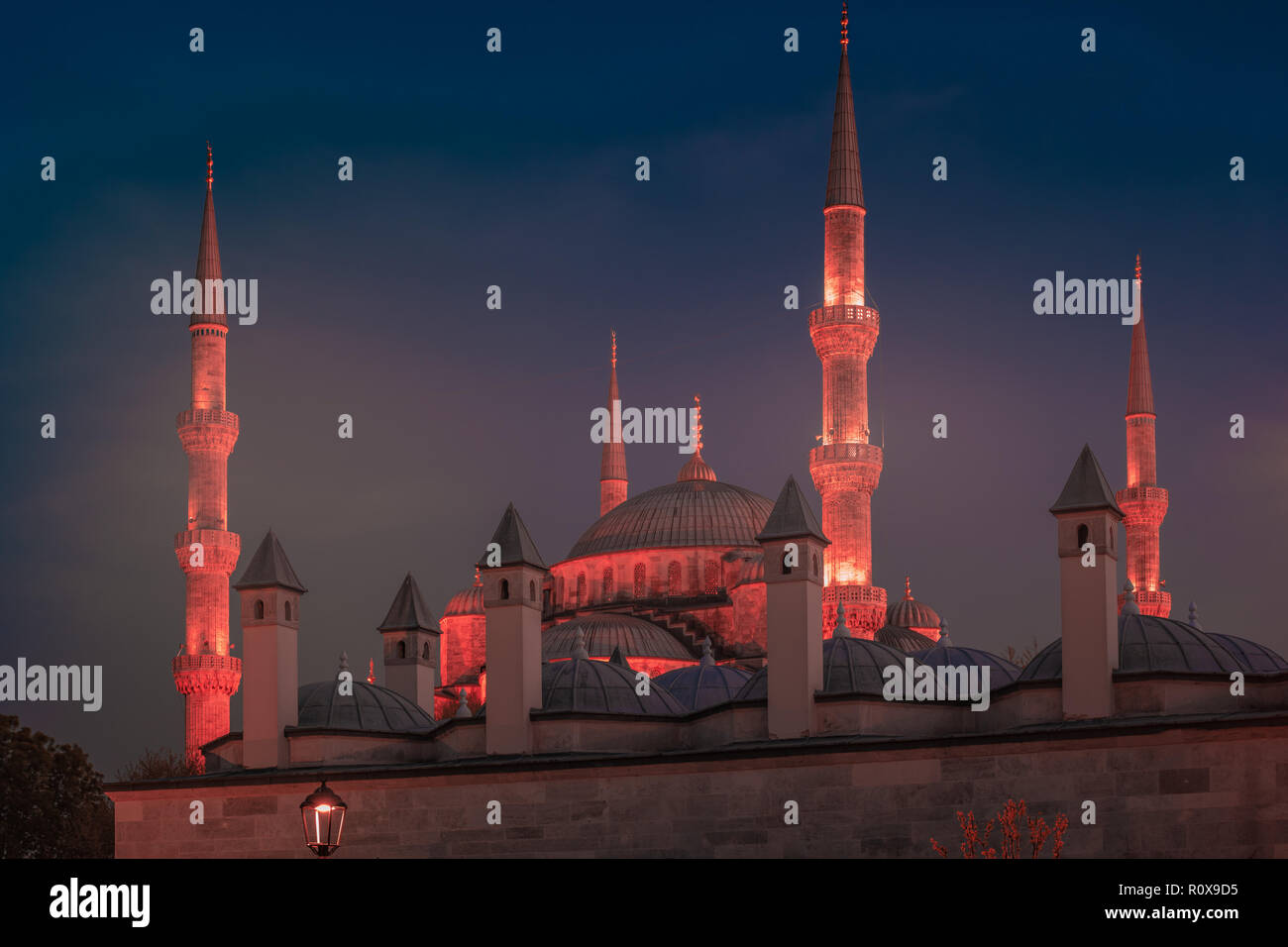 Blue Mosque at night with golden illumination, wide view of Istanbul in ...