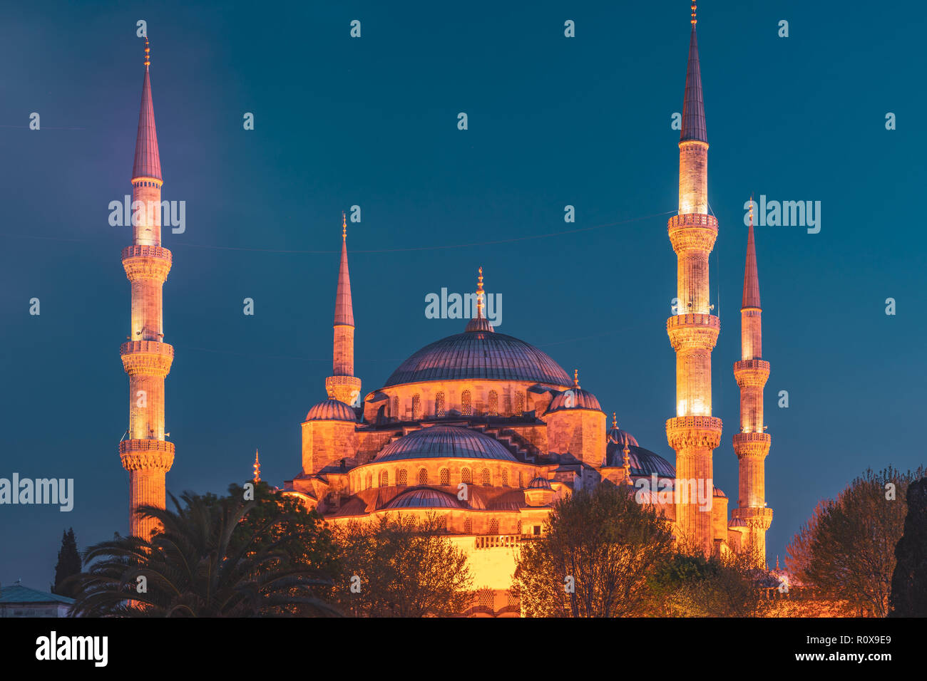 Blue Mosque at night with golden illumination, wide view of Istanbul in ...