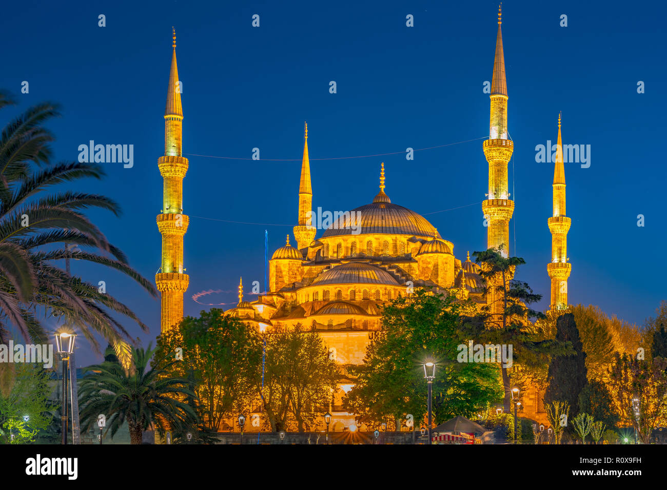 Blue Mosque at night with golden illumination, wide view of Istanbul in ...