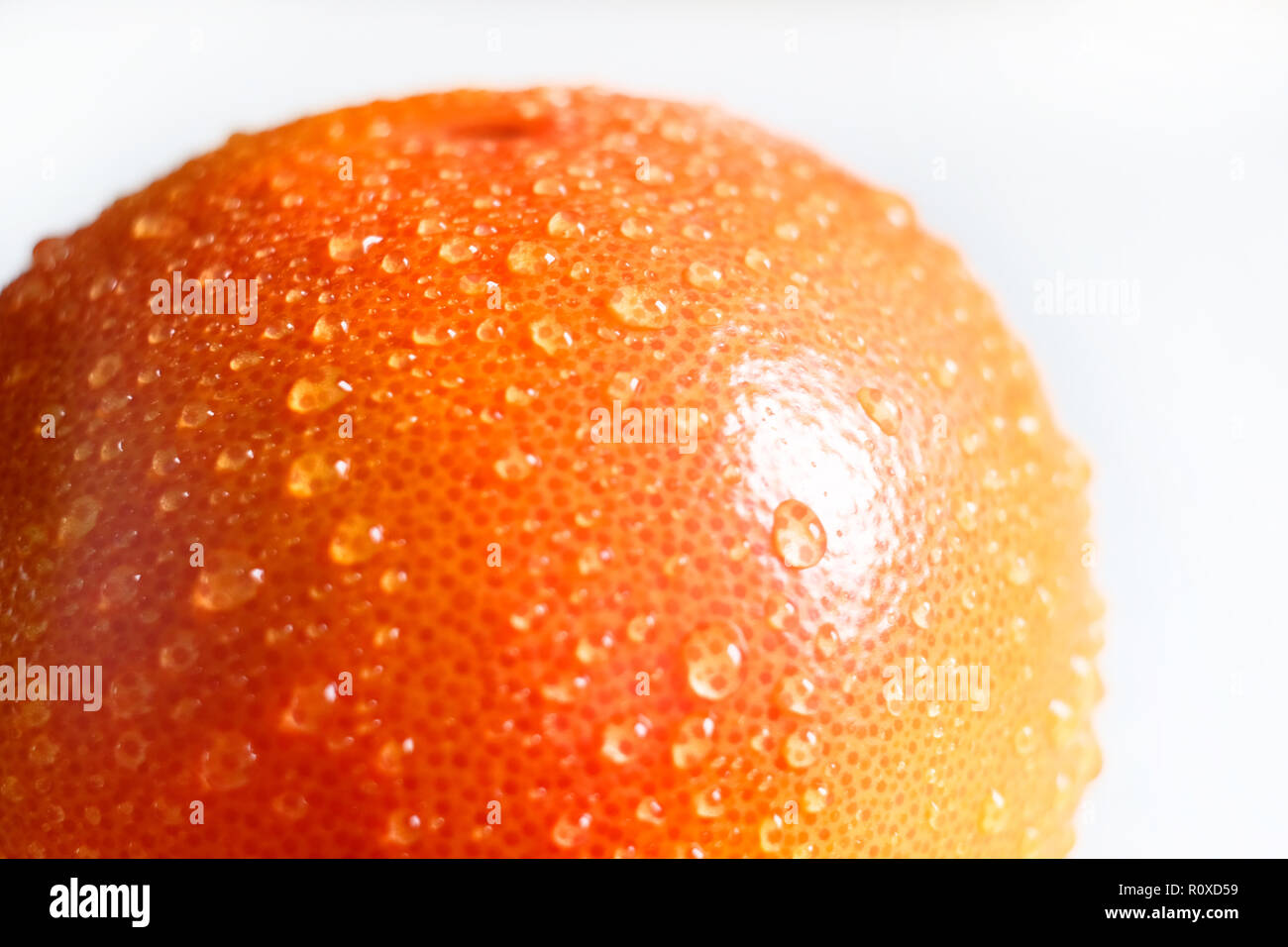 Grapefruit with water droplets on the skin. Closeup of the fuzzy focus