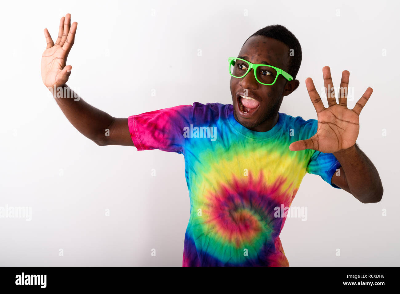 Studio shot of young scared black African man looking afraid and Stock Photo