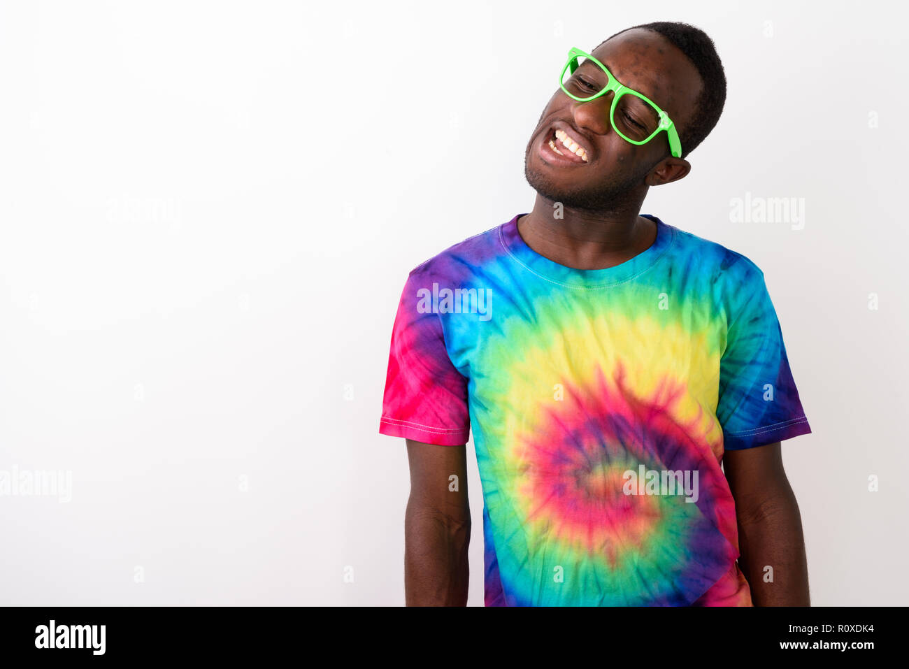 Studio shot of young black African man having neck pain against  Stock Photo
