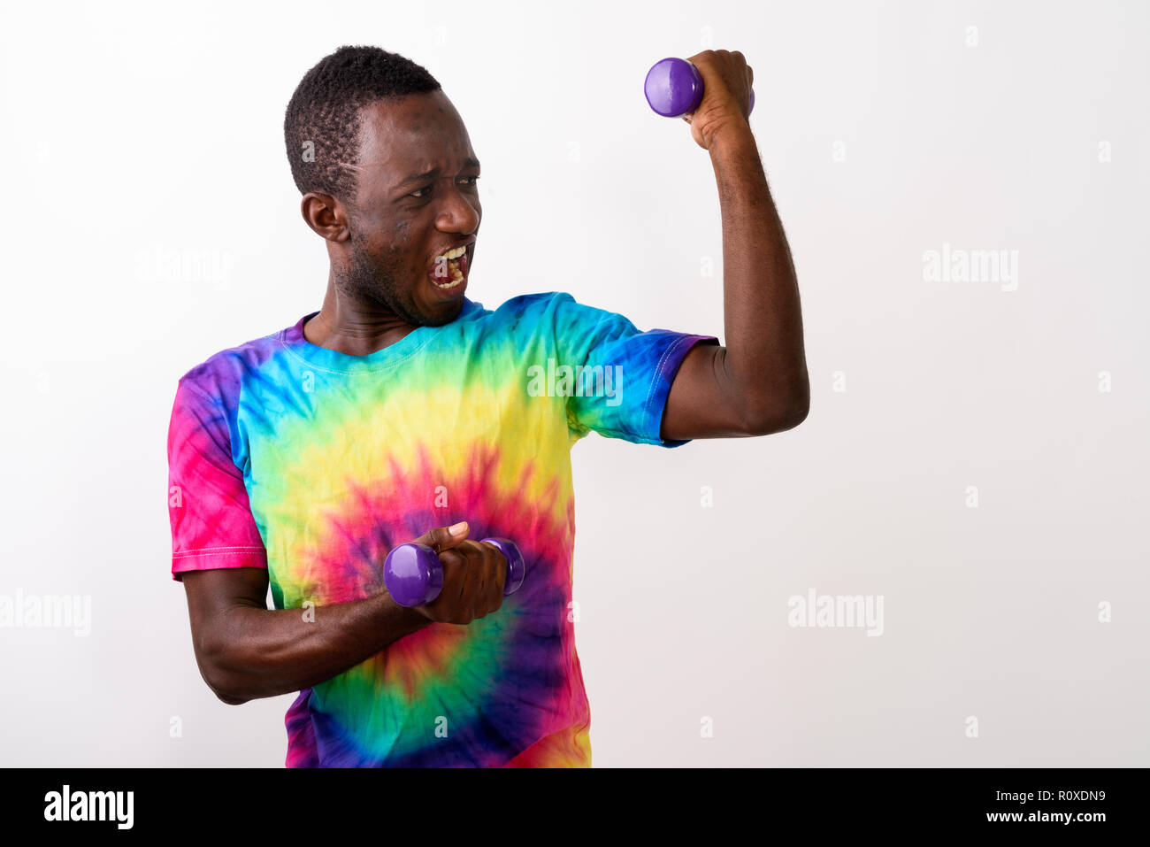 Studio shot of young black African man feeling powerful while ho Stock Photo