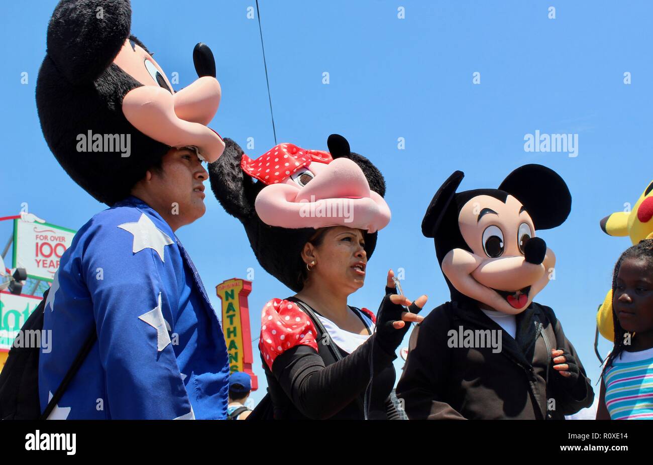 hispanic men and women dressed as cartoon characters mickey and minnie mouse  and pikachu on coney island boardwalk brooklyn new york uSA Stock Photo -  Alamy