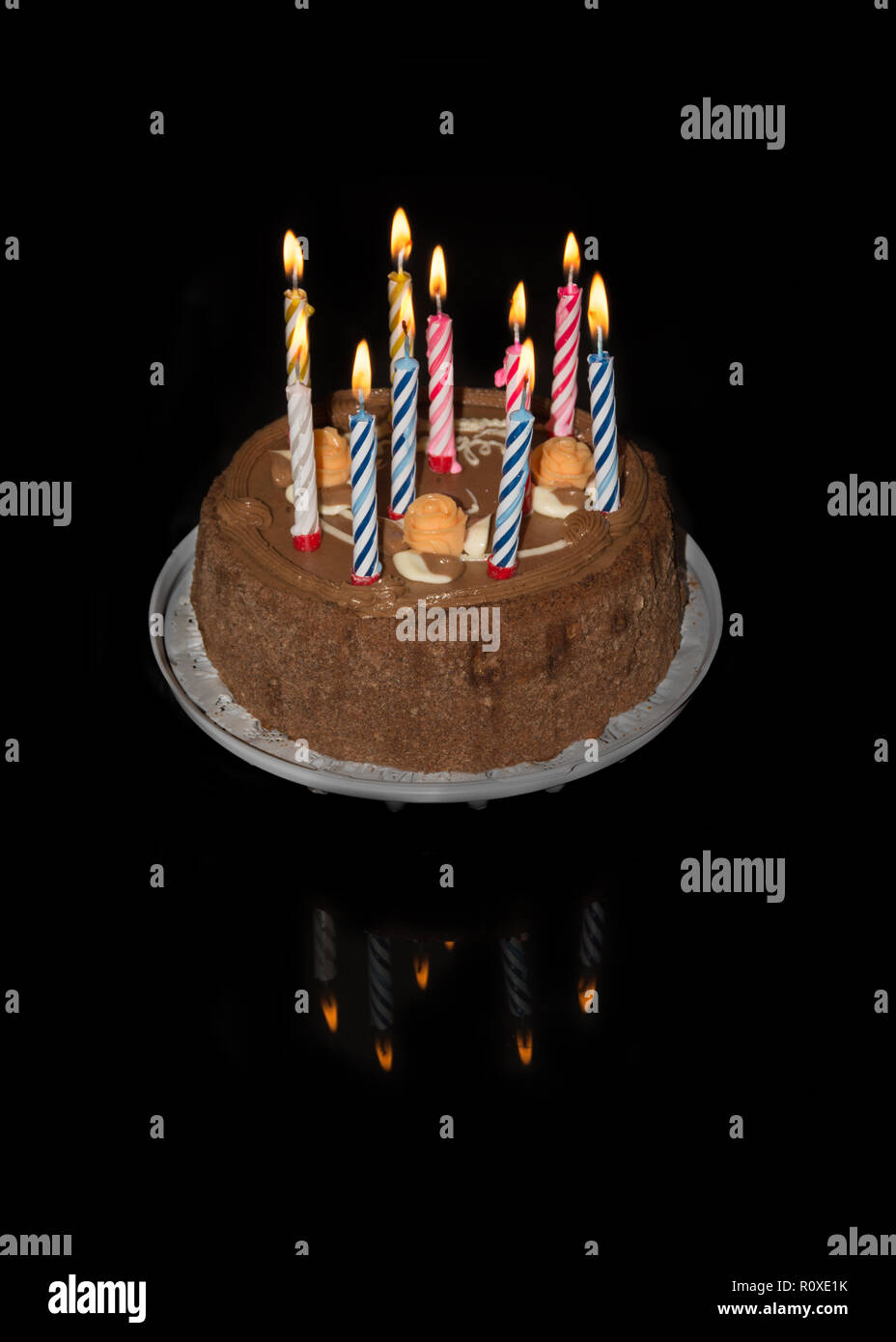 birthday cake on black background with five colorful lit candles. top ...