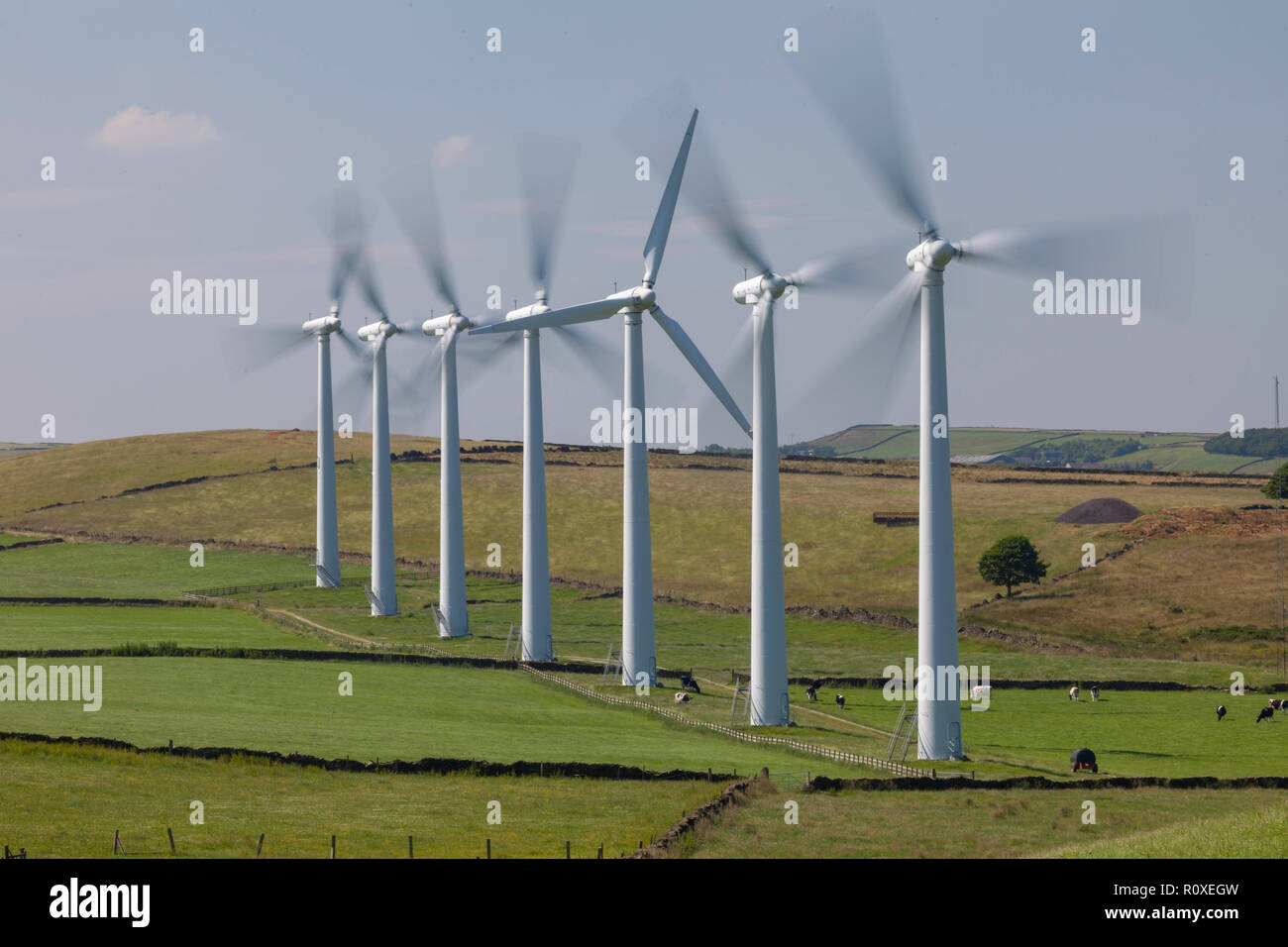 Spinning turbines of Hazlehead wind farm on the hills above Penistone