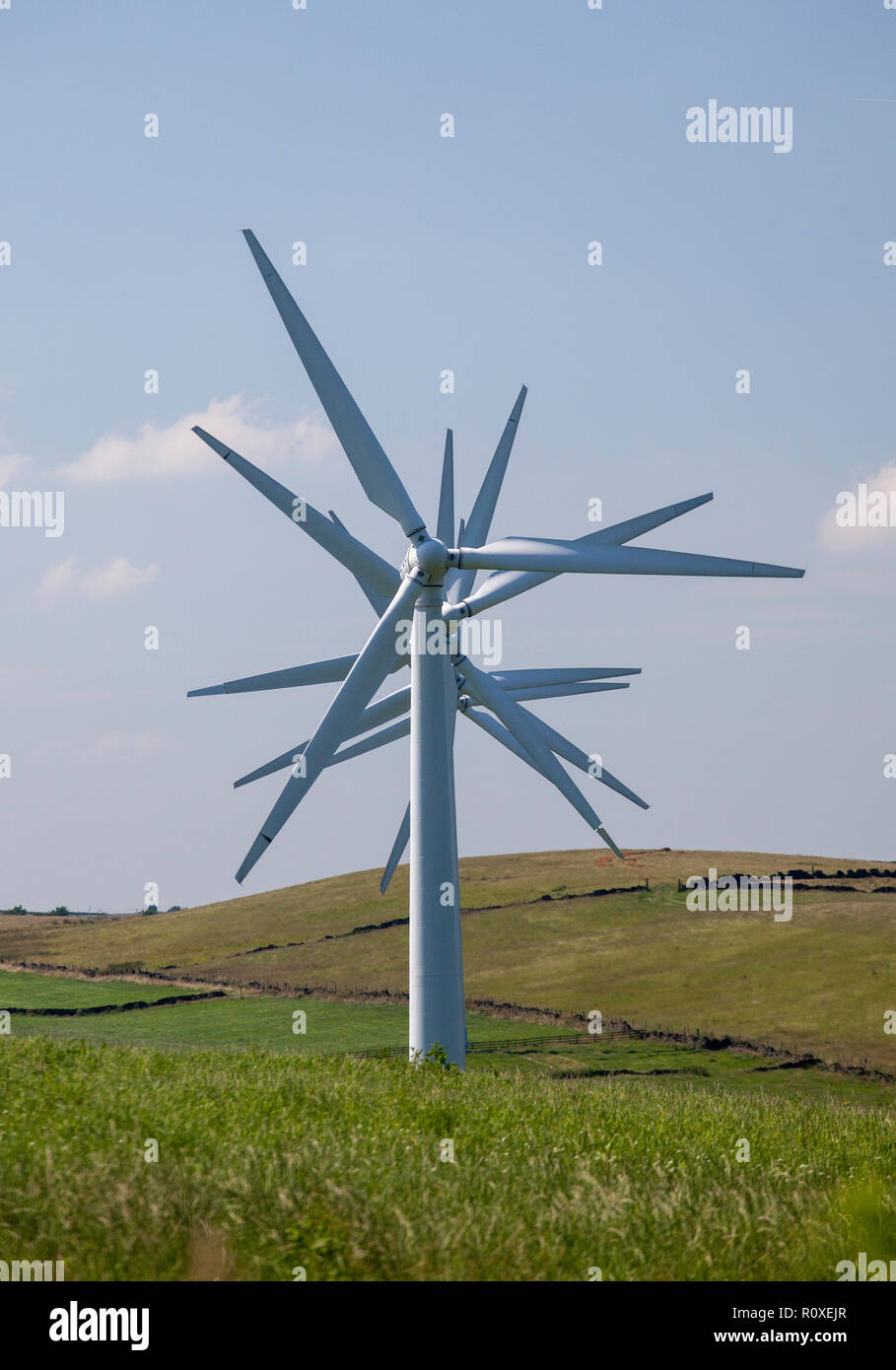 Spinning turbines of Hazlehead wind farm on the hills above Penistone
